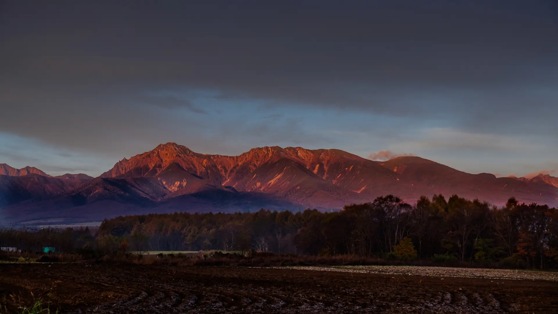 Mount Yatsugatake tinted red at sunrise over Yamanashi